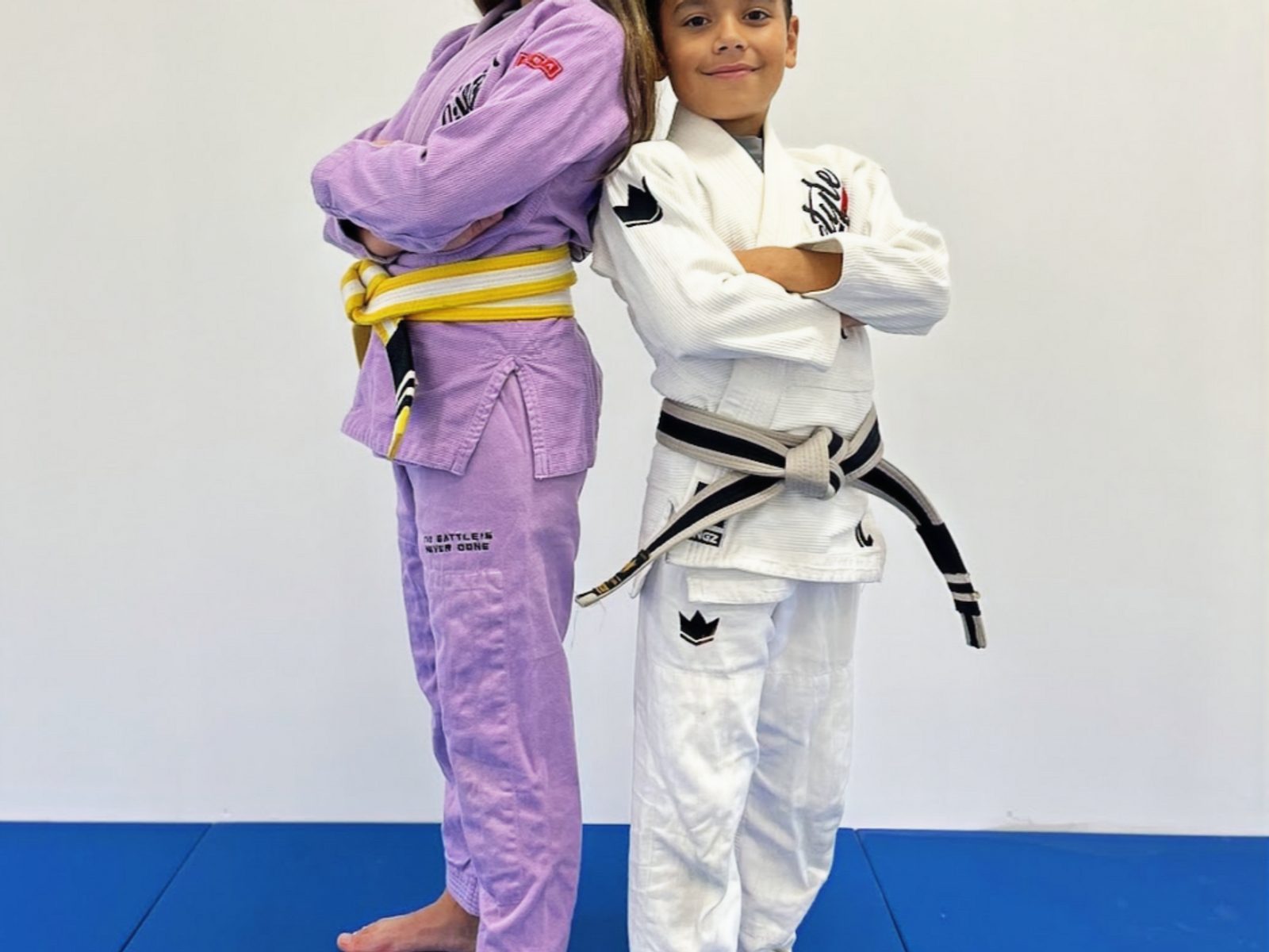 Two kids posing confidently in BJJ gis